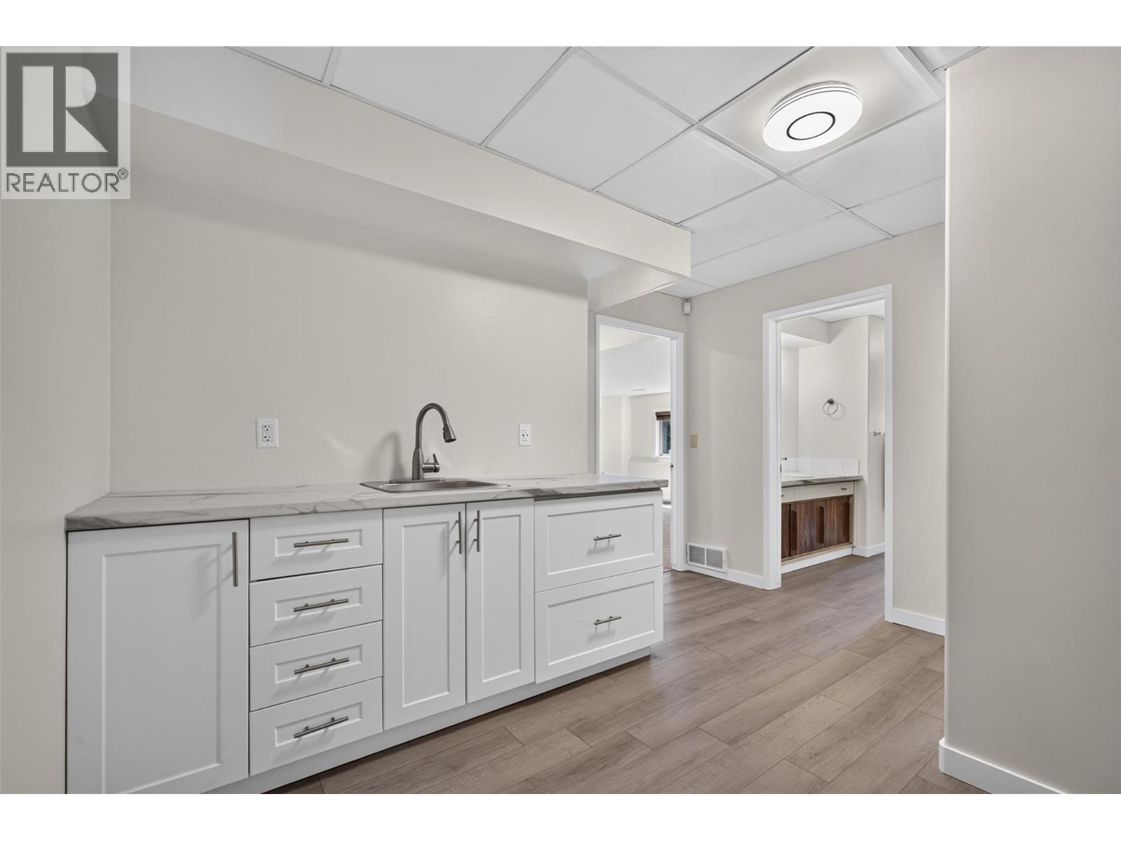 Kitchen sink/cabinets near recreation room - 602 Glenmeadows Road, Kelowna, BC - Indoor