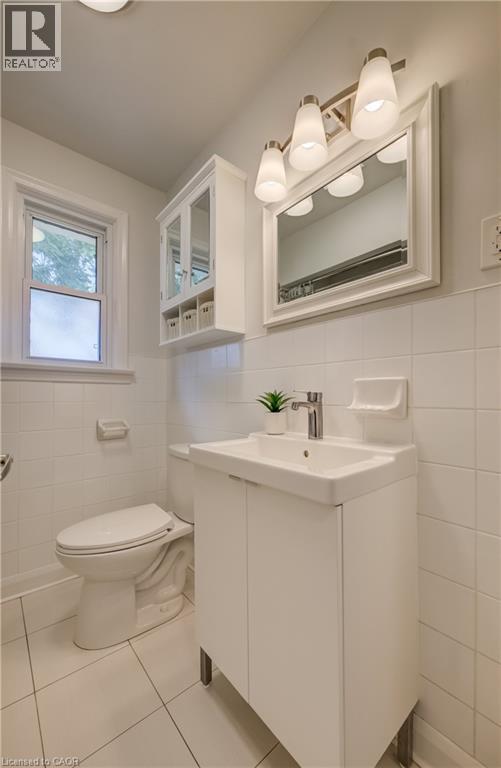 White ceramic tile flooring and wall surround - 55 Rex Drive, Kitchener, ON - Indoor Photo Showing Bathroom