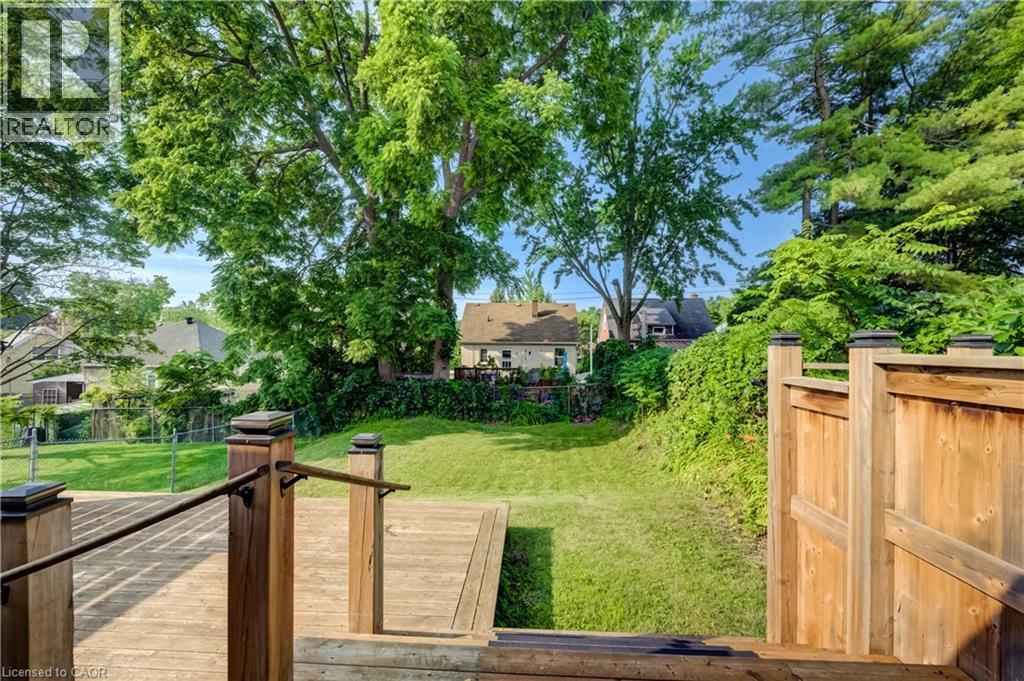 Expansive outdoor deck with natural wood planks and dark metal railings - 55 Rex Drive, Kitchener, ON - Outdoor