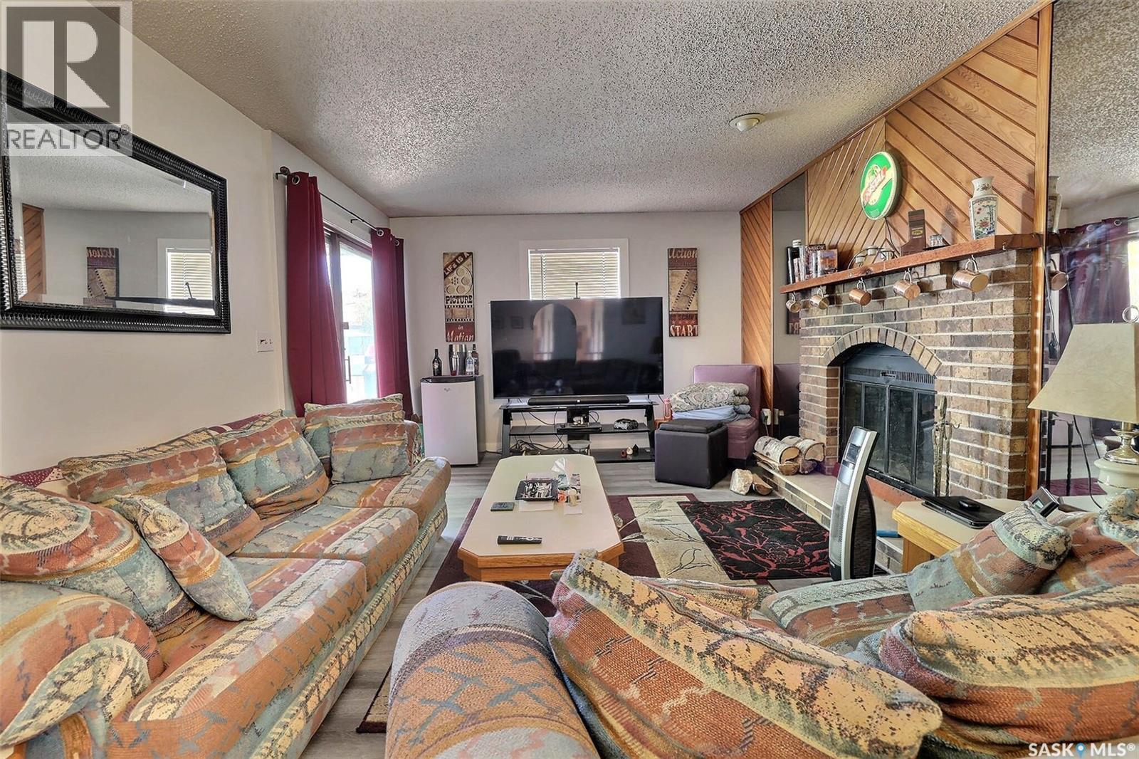 122 Edenwold Crescent, Regina, SK - Indoor Photo Showing Living Room With Fireplace