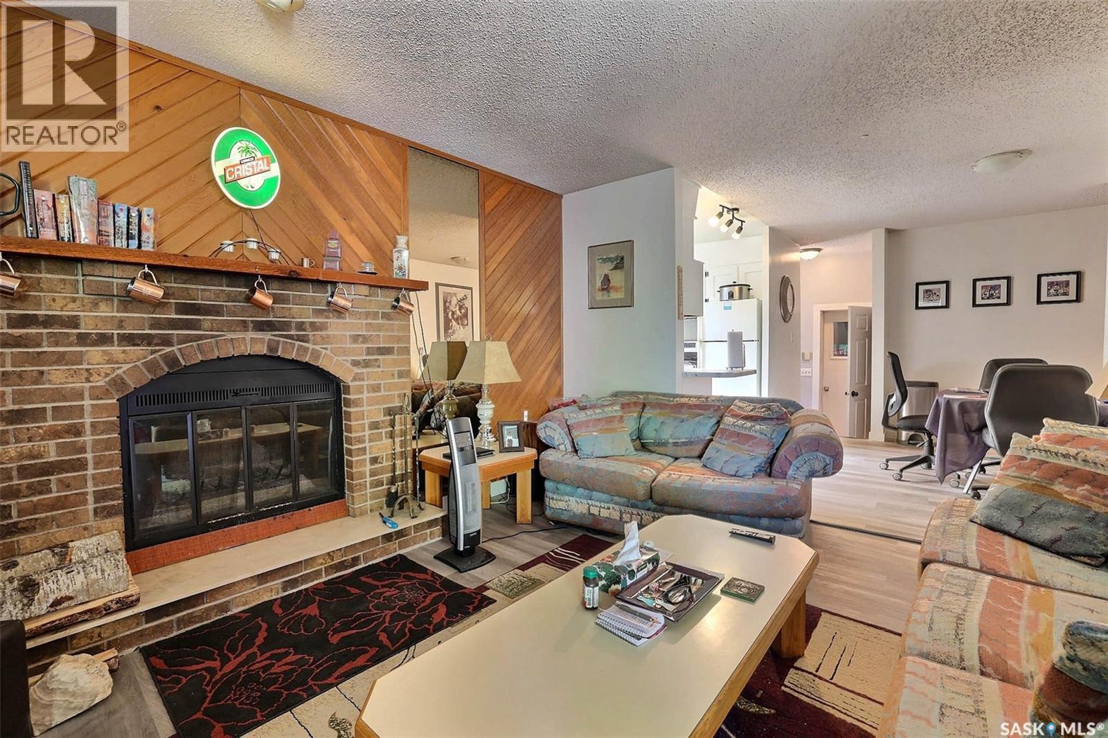122 Edenwold Crescent, Regina, SK - Indoor Photo Showing Living Room With Fireplace