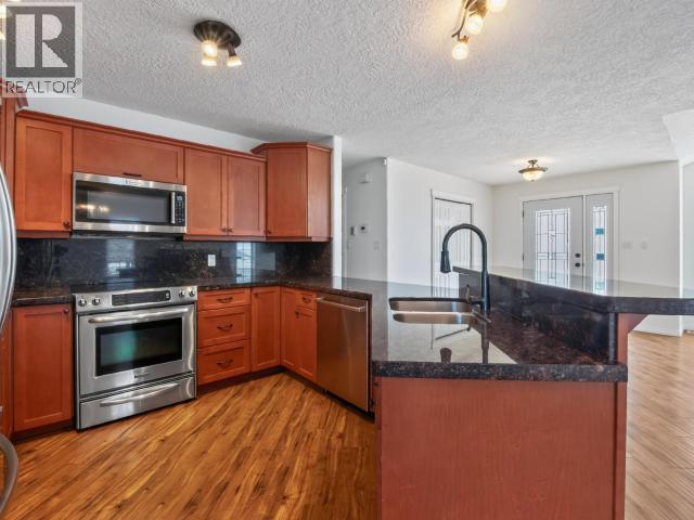 4 Ruby Lane, Whitehorse, YT - Indoor Photo Showing Kitchen With Stainless Steel Kitchen With Double Sink