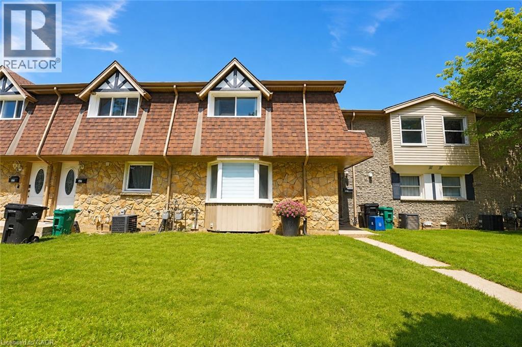 Stone facade with dormer windows, a bay window, and a gabled roofline - 136 Jansen Avenue, Kitchener, ON - Outdoor