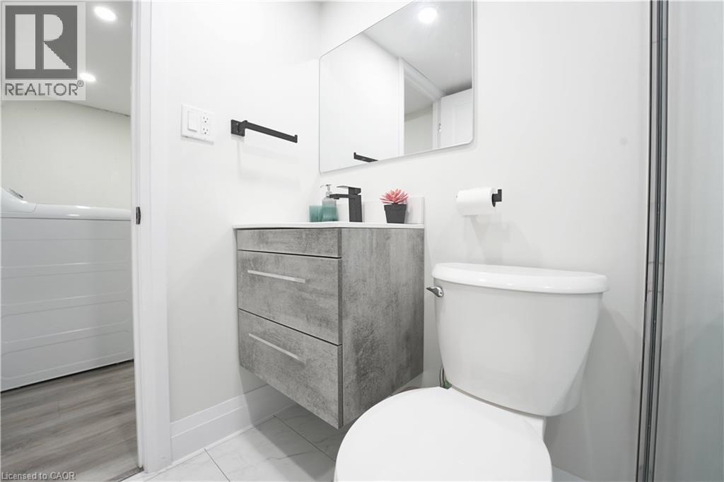 Bathroom featuring a floating vanity with a light gray countertop and a black single-handle faucet - 136 Jansen Avenue, Kitchener, ON - Indoor Photo Showing Bathroom