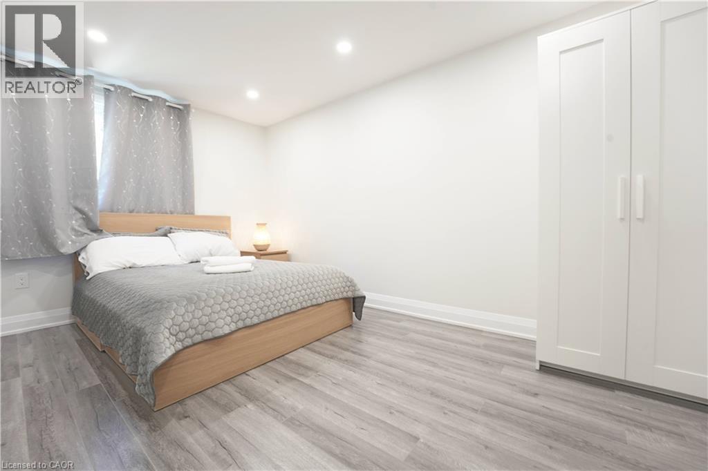 Spacious room featuring light wood-finish flooring and recessed lighting - 136 Jansen Avenue, Kitchener, ON - Indoor Photo Showing Bedroom