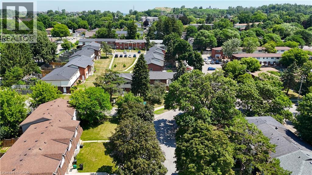 Aerial perspective of a residential complex featuring multiple buildings with gabled roofs and brick exteriors - 136 Jansen Avenue, Kitchener, ON - Outdoor With View