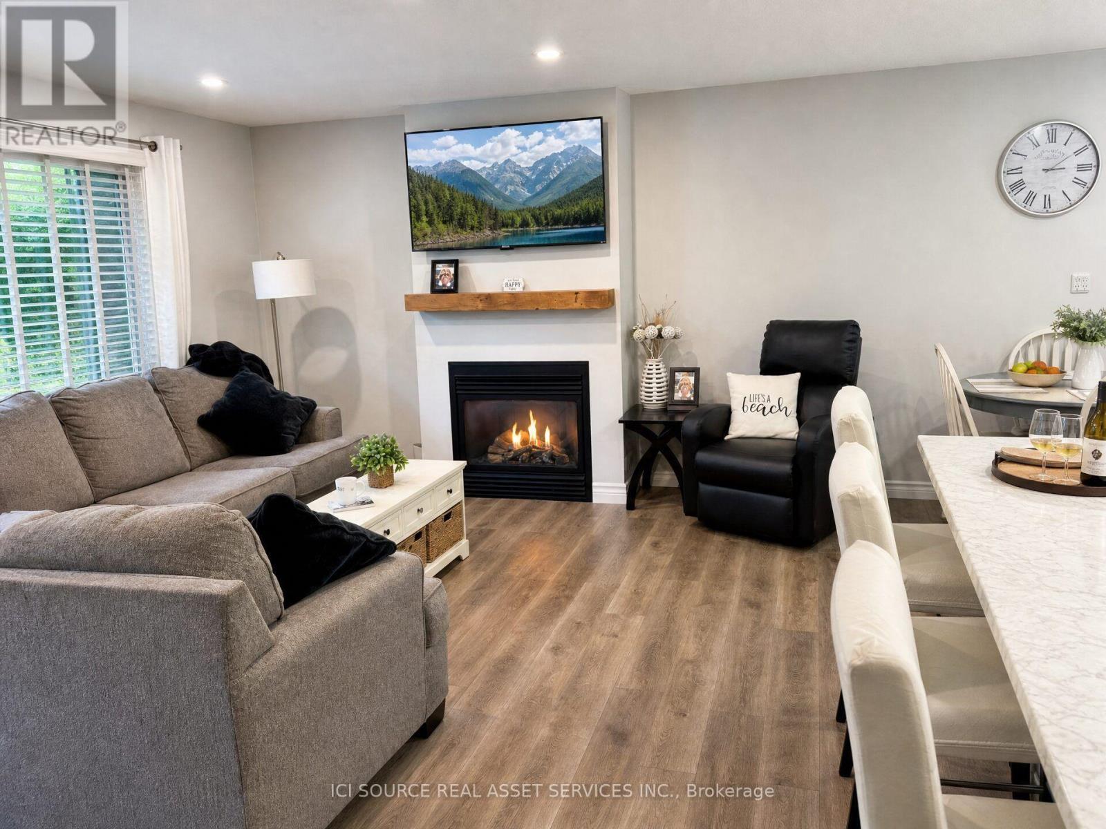 110 Wolfe Trail, Tiny, ON - Indoor Photo Showing Living Room With Fireplace