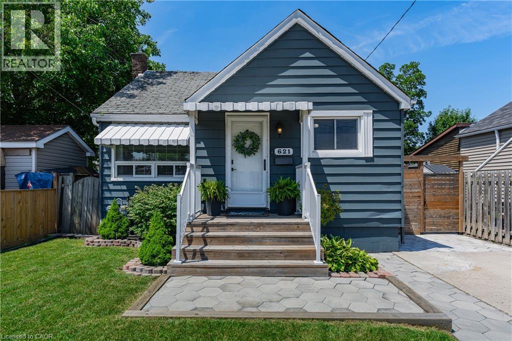Bungalow exterior featuring horizontal siding, white trim, and a gabled roof - 621 Tate Avenue, Hamilton, ON - Outdoor