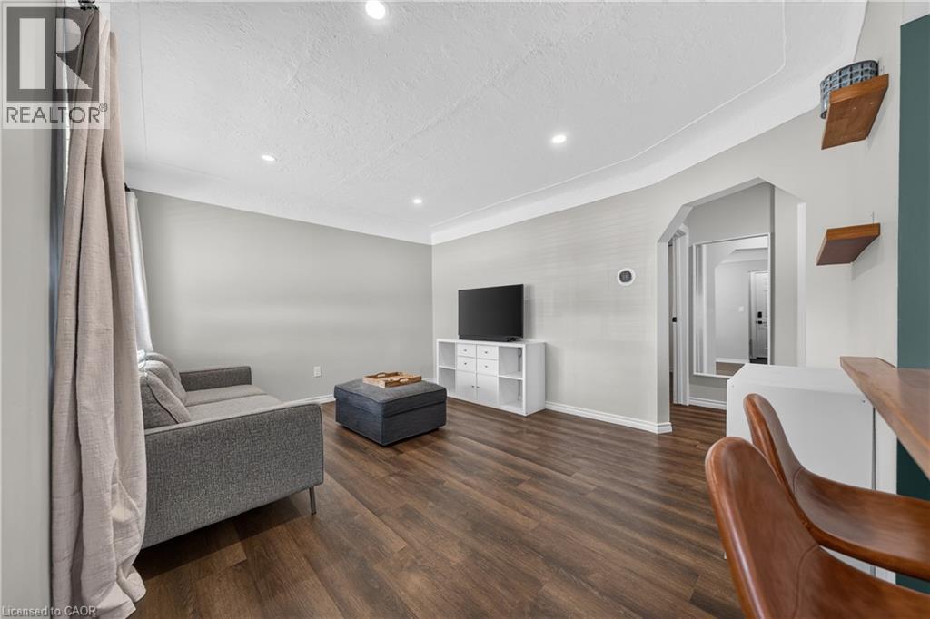 Living area featuring wood-finish flooring, recessed lighting, and a neutral color palette - 621 Tate Avenue, Hamilton, ON - Indoor