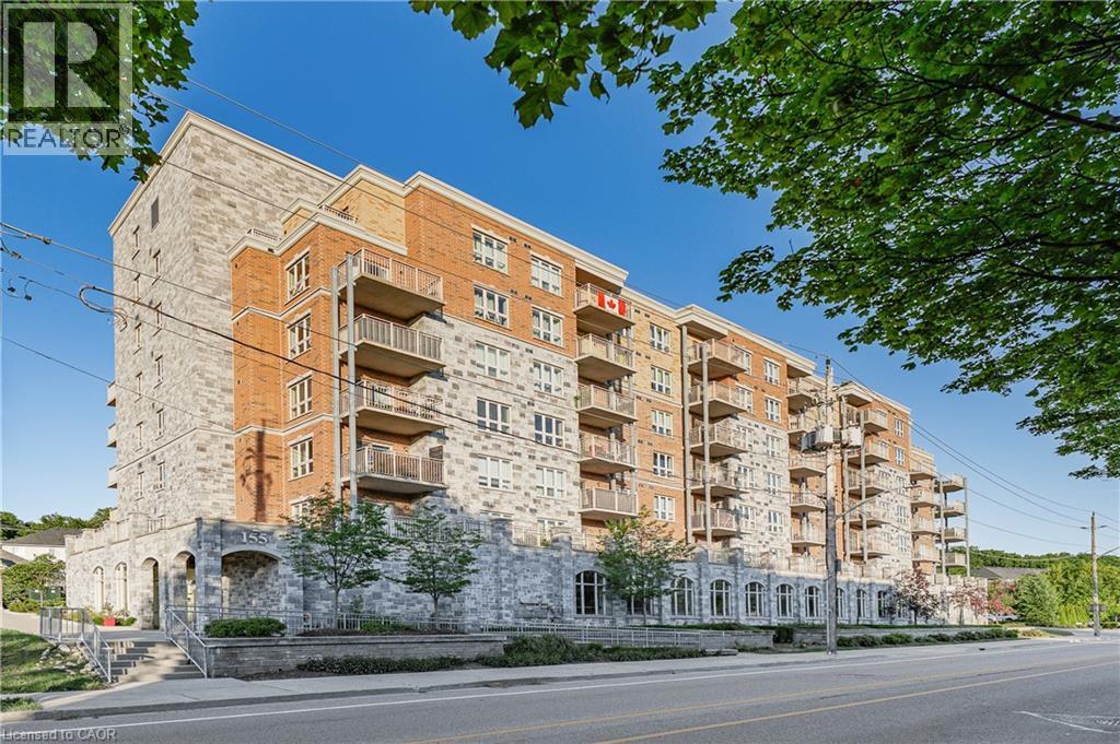 Multi-story residential building featuring a stone and brick facade - 155 Water Street S Unit# 203, Cambridge, ON - Outdoor With Facade