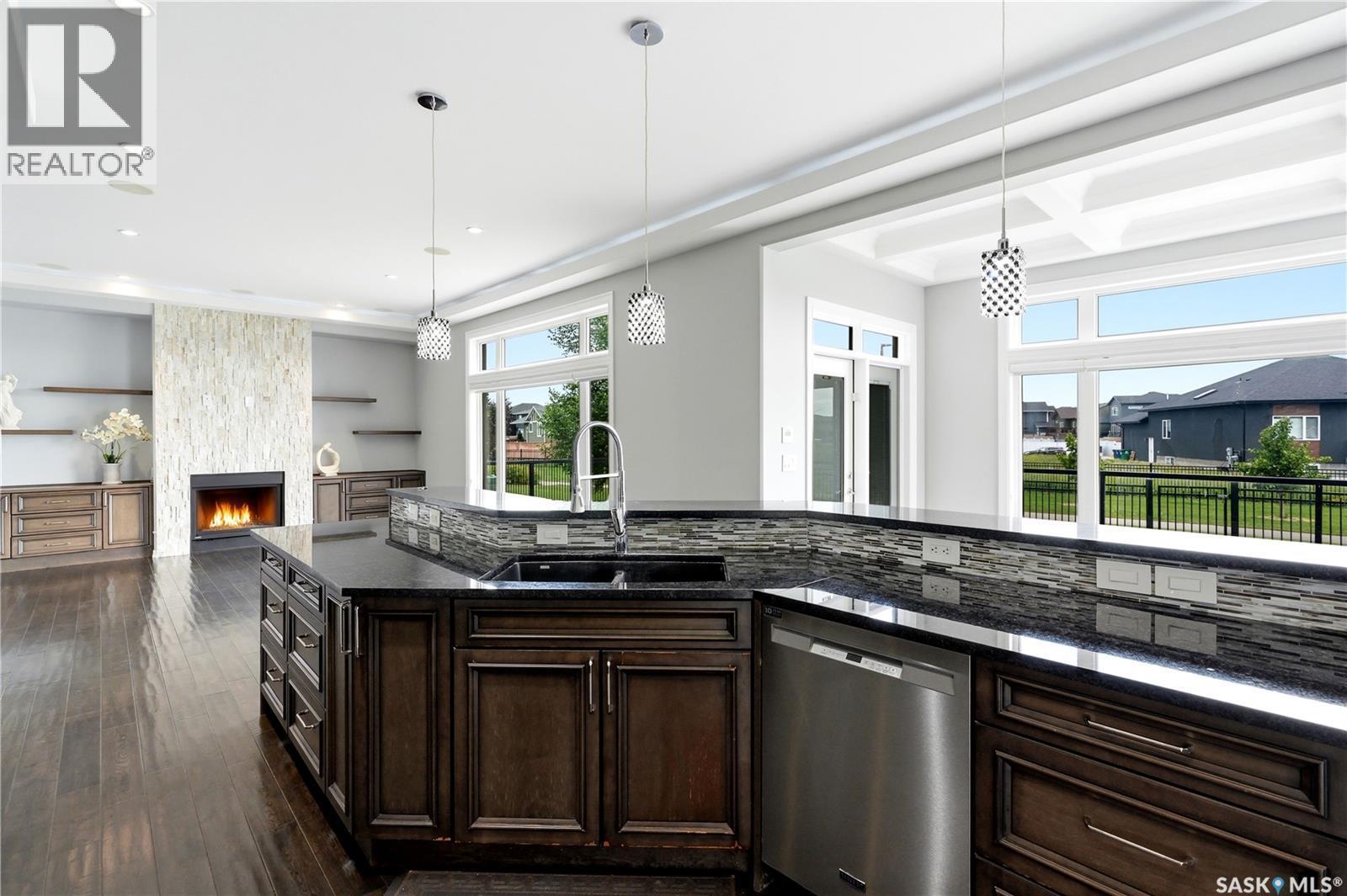 138 Flegel Court, Saskatoon, SK - Indoor Photo Showing Kitchen With Fireplace With Double Sink With Upgraded Kitchen