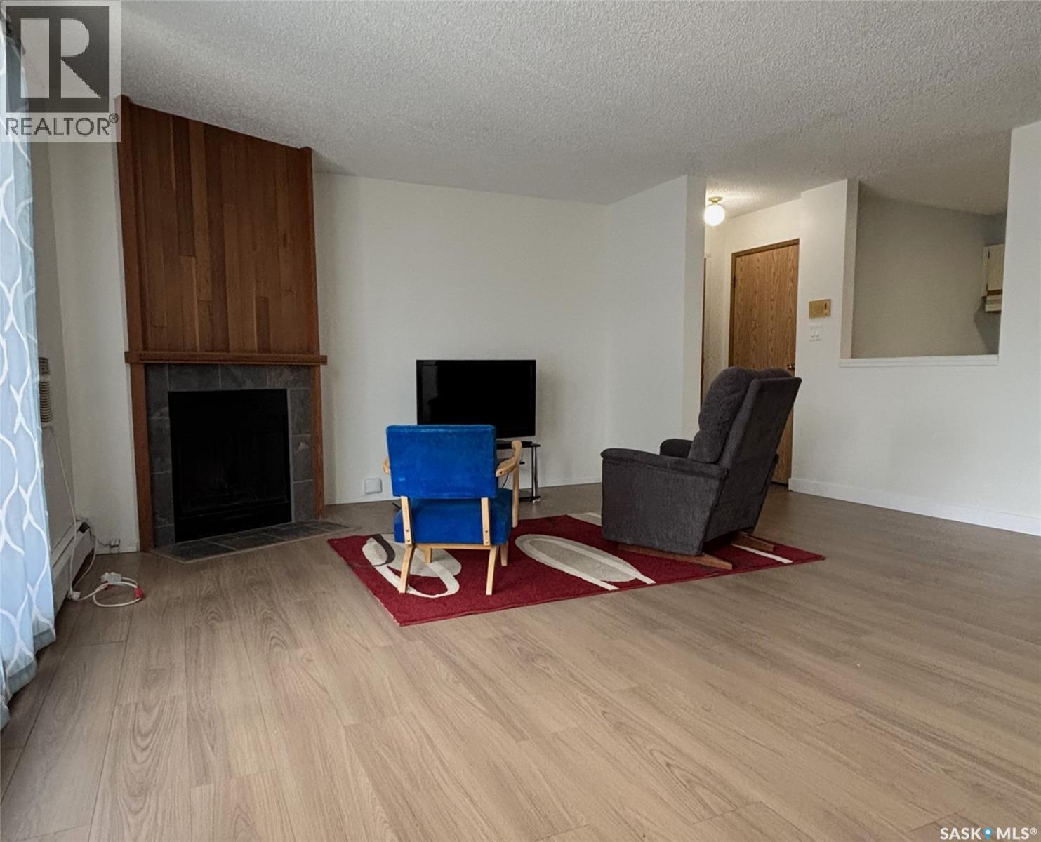 202 - 385 Kingsmere Boulevard, Saskatoon, SK - Indoor Photo Showing Living Room With Fireplace