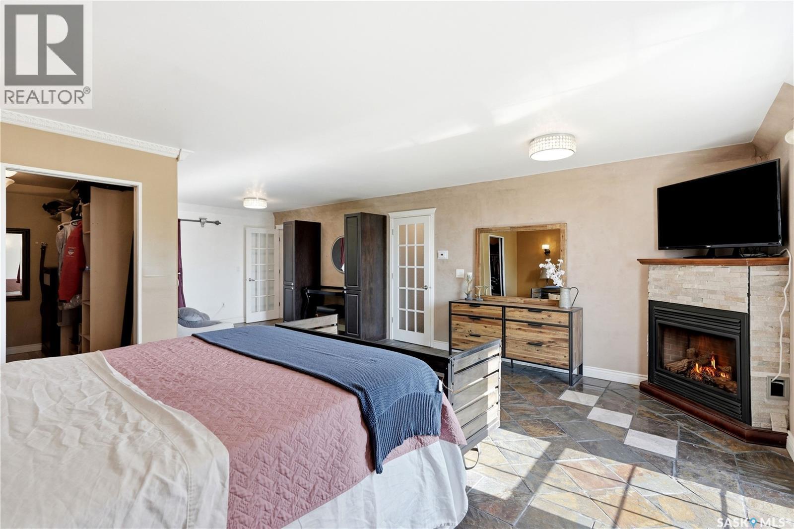 308 3Rd Street W, Delisle, SK - Indoor Photo Showing Bedroom With Fireplace