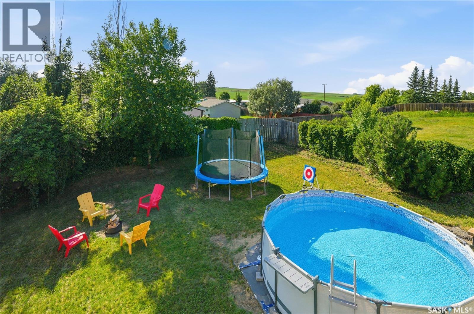 308 3Rd Street W, Delisle, SK - Outdoor With Above Ground Pool With Backyard