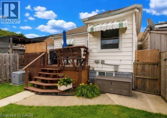 Private backyard featuring a multi-level wood deck, concrete patio, and fenced perimeter - 237 Paling Avenue, Hamilton, ON - Outdoor With Deck Patio Veranda