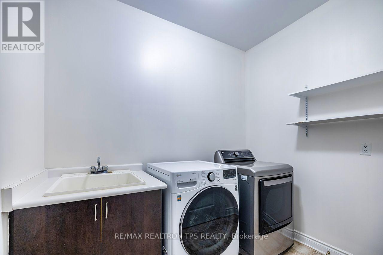 Main Floor Laundry Room with Access to Garage - 555 Kingsfield Loop, Oshawa, ON - Indoor Photo Showing Laundry Room