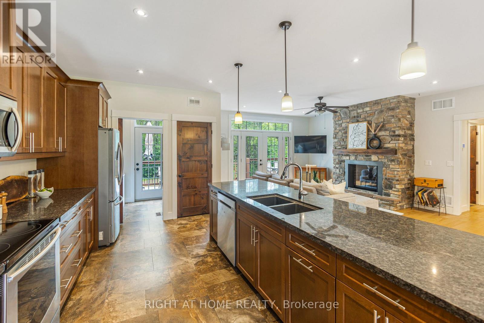 590 Golf Course Road, Douro-Dummer, ON - Indoor Photo Showing Kitchen With Fireplace With Double Sink With Upgraded Kitchen