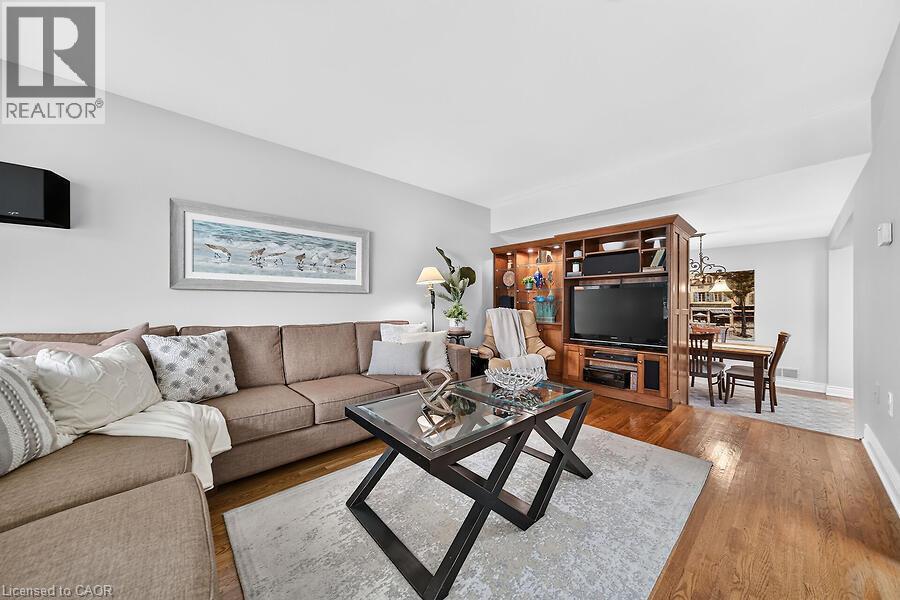 Open-concept living space with wood-finish flooring - 30 Carriagegate Drive, Hamilton, ON - Indoor Photo Showing Living Room