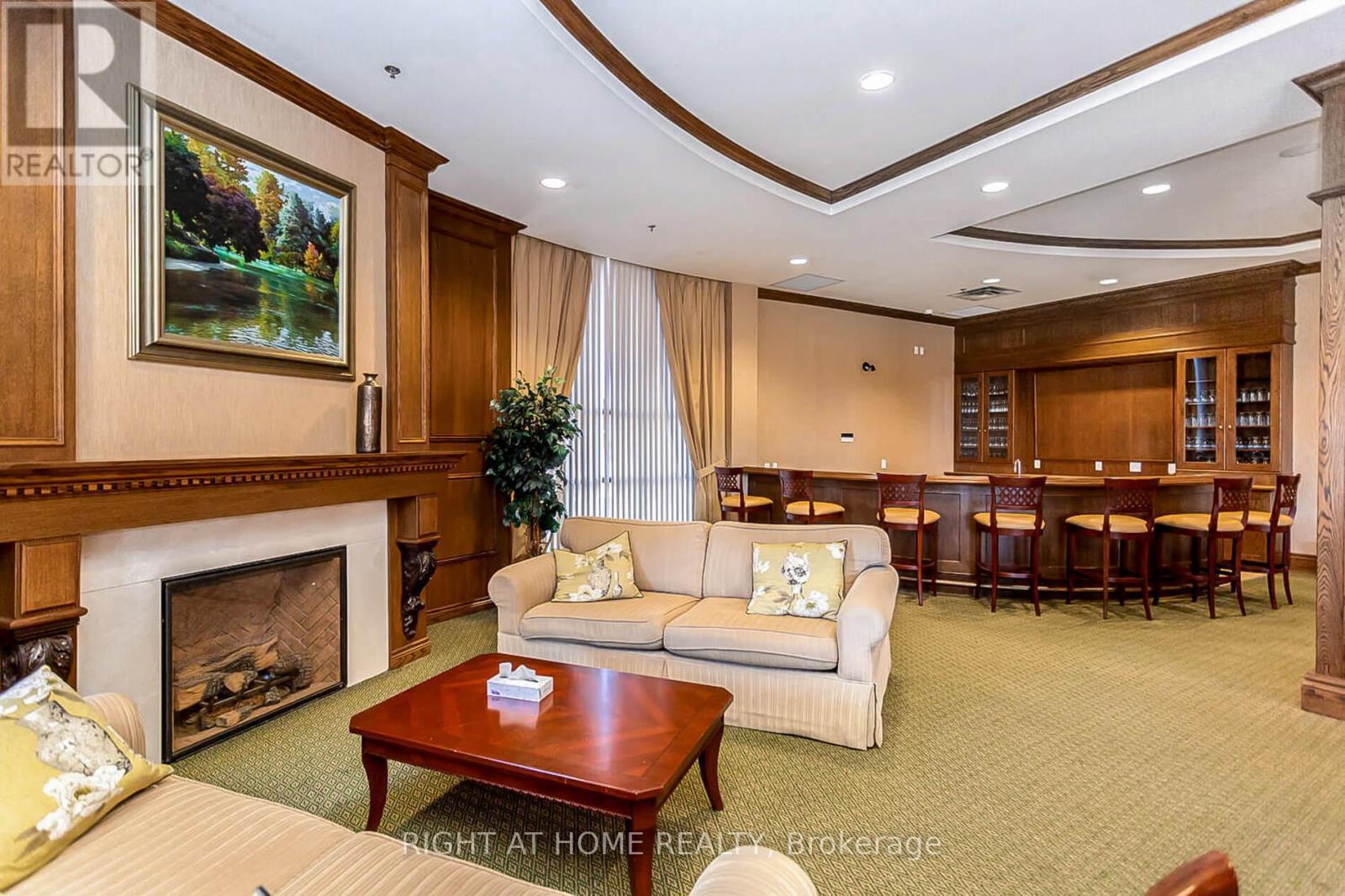 318 - 40 Via Rosedale, Brampton, ON - Indoor Photo Showing Living Room With Fireplace