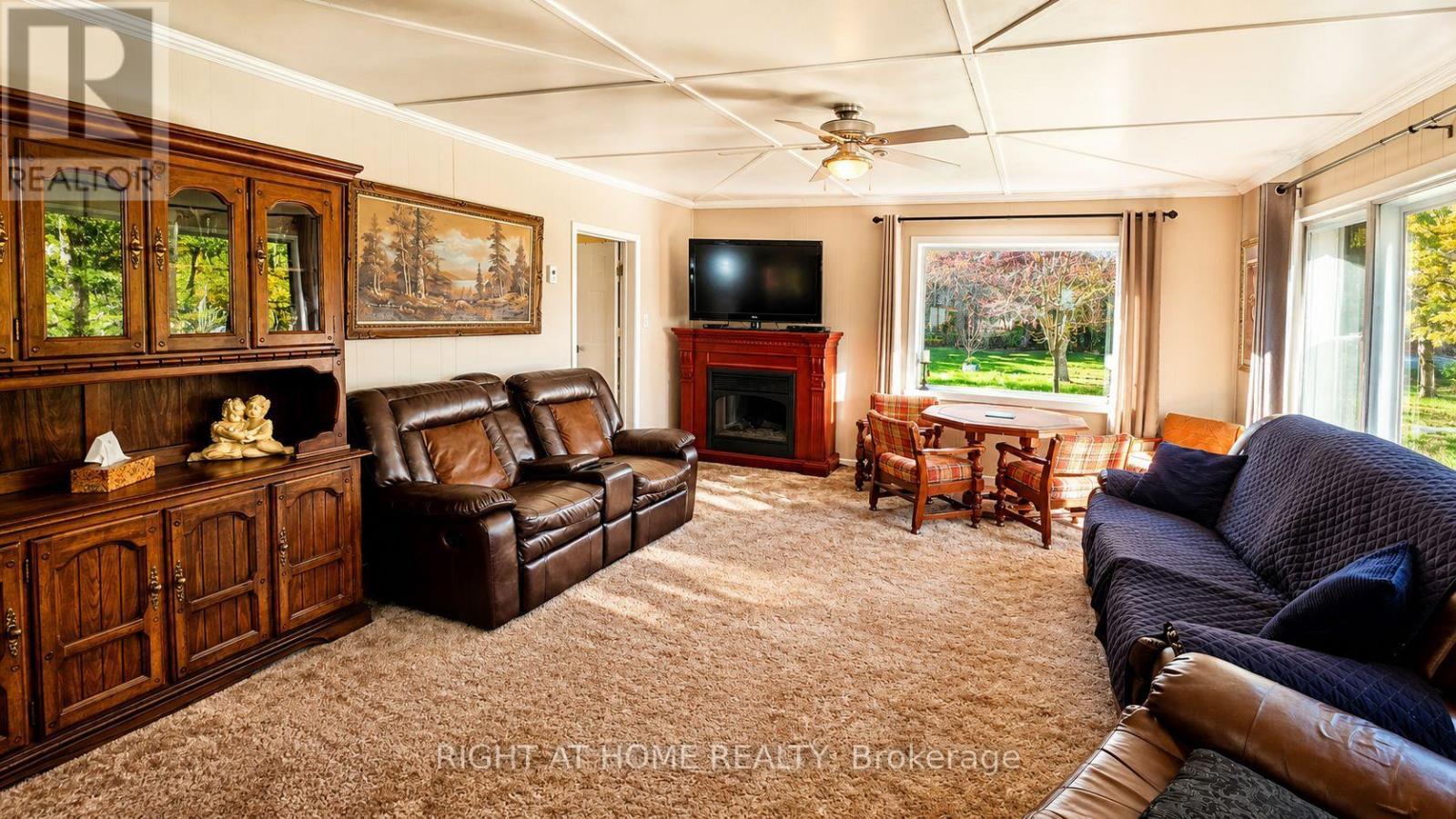 640 Tiny Beaches Road N, Tiny, ON - Indoor Photo Showing Living Room With Fireplace