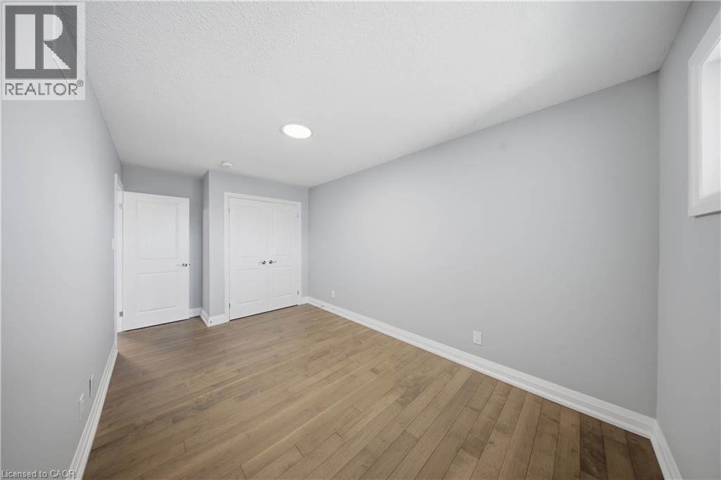 Room featuring wood-finish flooring, light gray wall paint, and recessed lighting - 107 Stephenson Way, Palmerston, ON - Indoor Photo Showing Other Room