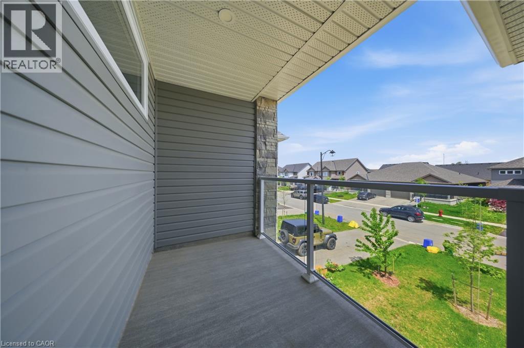 Balcony featuring concrete flooring and a glass railing system - 107 Stephenson Way, Palmerston, ON - Outdoor With Balcony With Exterior
