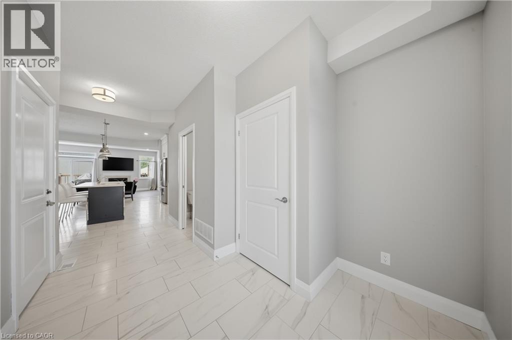 Tiled entryway featuring light-colored flooring, neutral wall tones, and white trim - 107 Stephenson Way, Palmerston, ON - Indoor Photo Showing Other Room