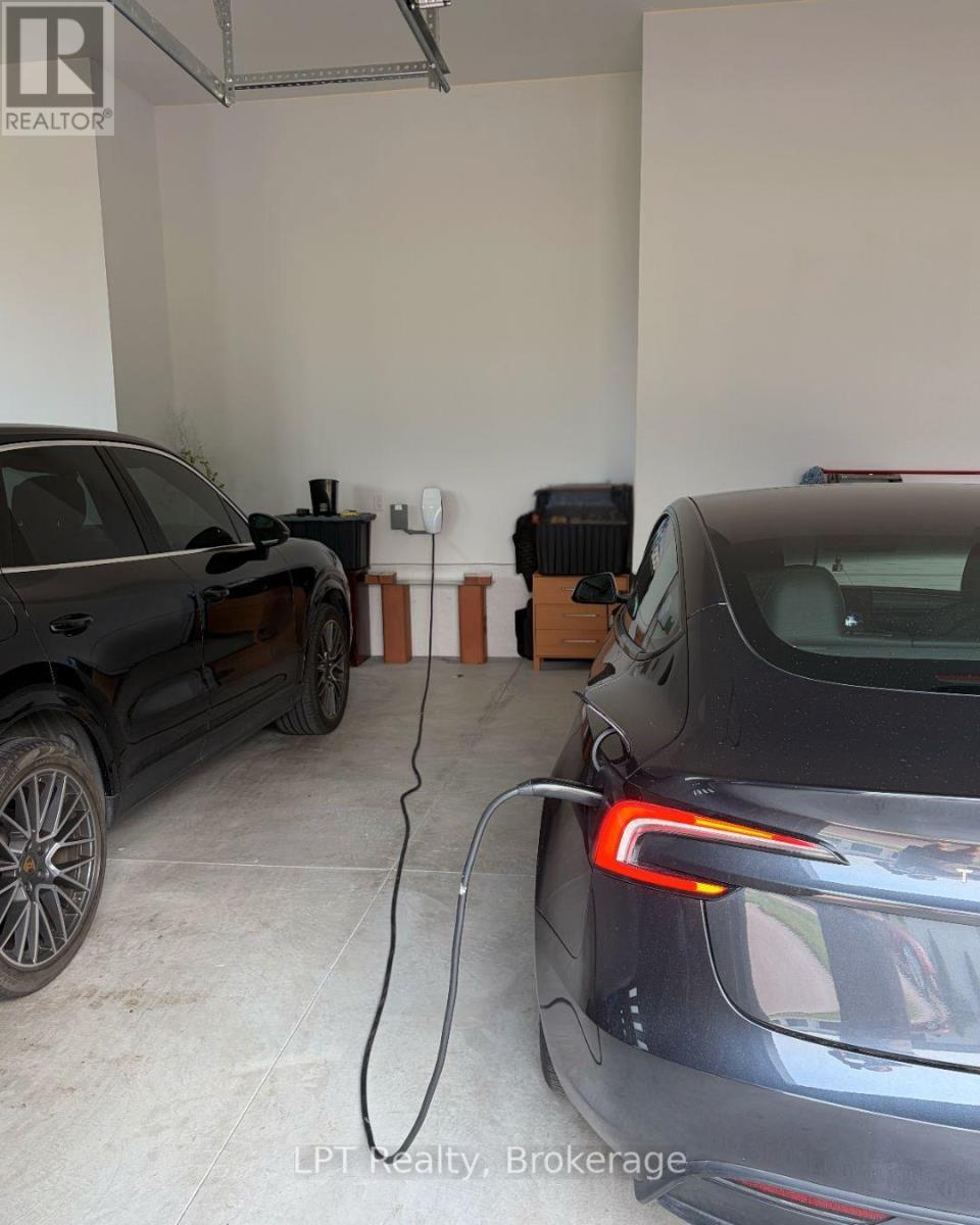 EV Charger In Garage - 67 Charles Tilley Crescent, Clarington, ON - Indoor Photo Showing Garage