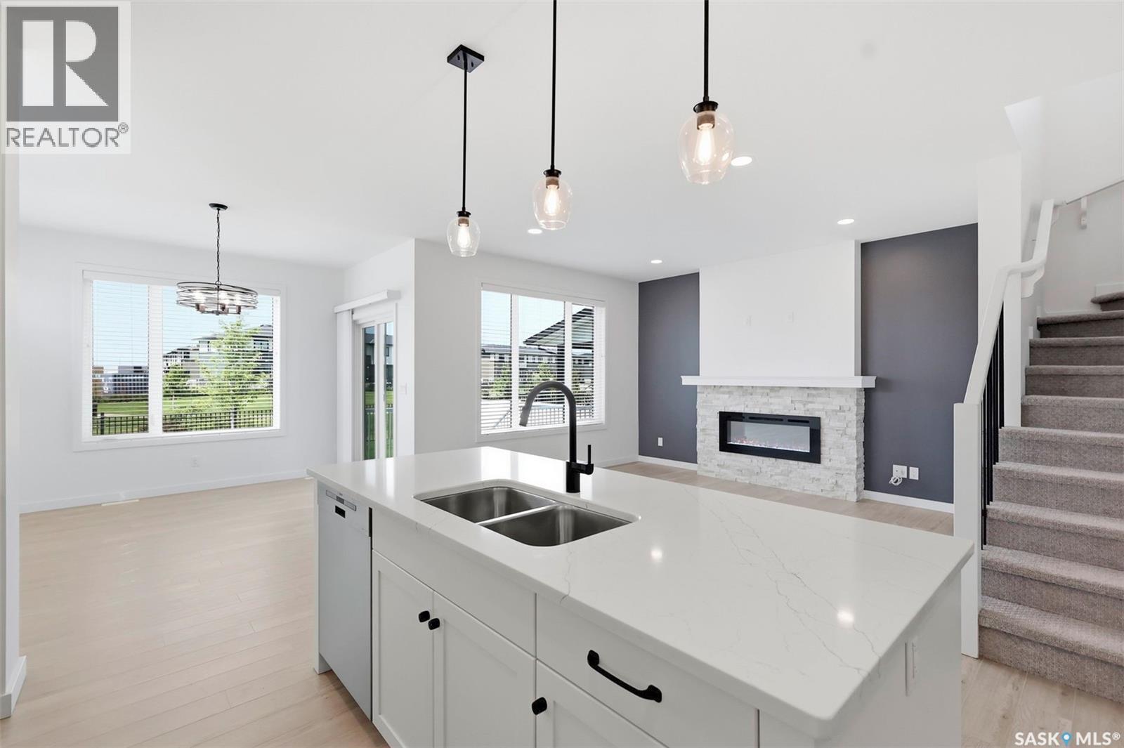 104 Forsey Avenue, Saskatoon, SK - Indoor Photo Showing Kitchen With Fireplace With Double Sink