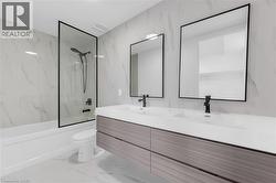Floating dual vanity with integrated sinks, wood-grain cabinetry, and matte black fixtures -
