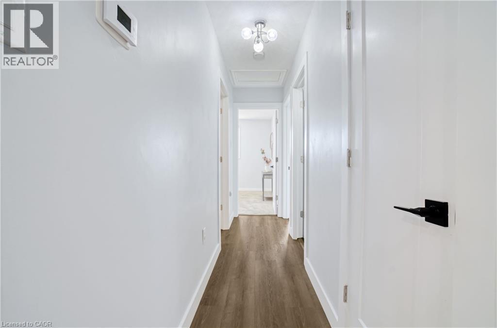 Hallway featuring wood-finish flooring, white walls, and white trim - 60 Lysanda Avenue, London, ON - Indoor Photo Showing Other Room