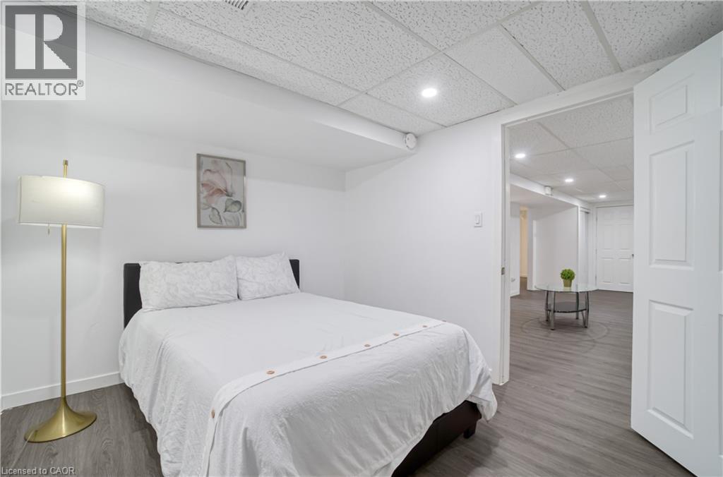 Room featuring white painted walls, recessed lighting, and wood-finish flooring - 60 Lysanda Avenue, London, ON - Indoor Photo Showing Bedroom