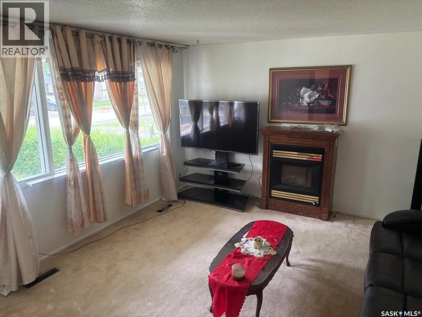 127 Walden Crescent, Regina, SK - Indoor Photo Showing Living Room With Fireplace