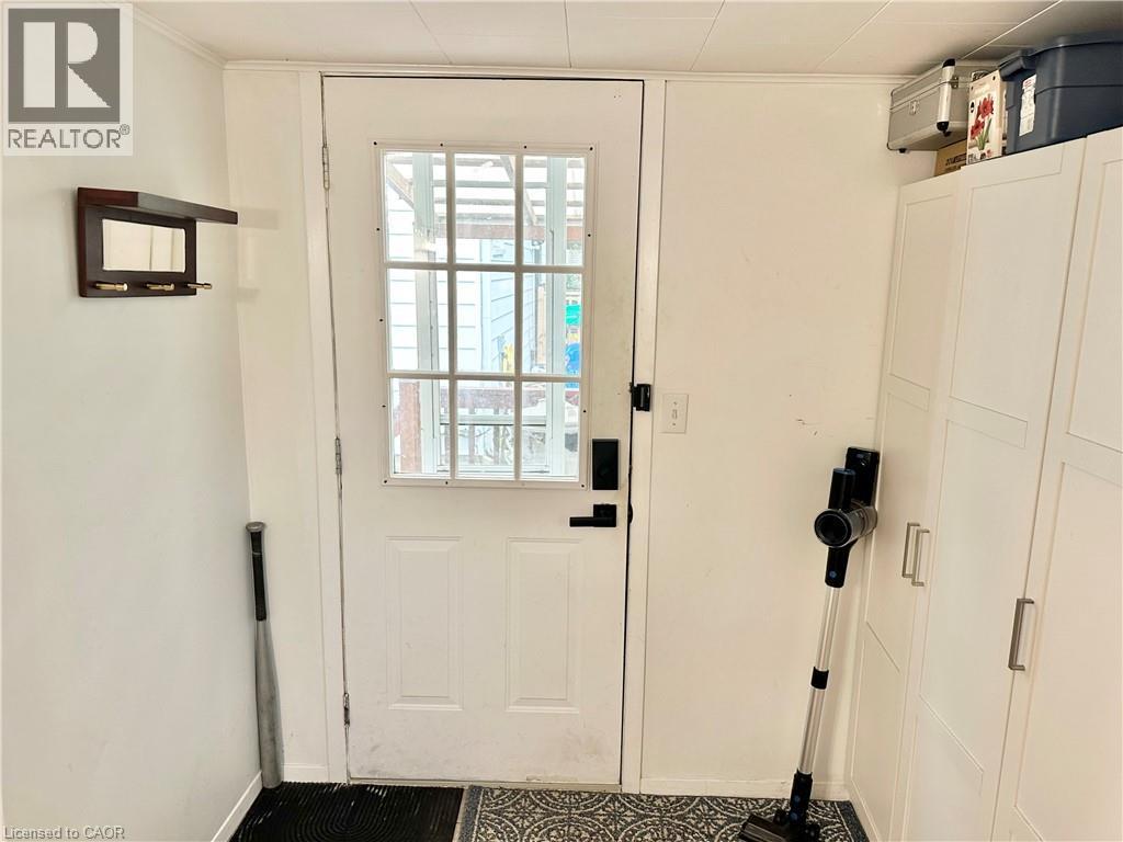 White paneled door with windowpanes, flanked by white walls - 88 Brook Street, Simcoe, ON - Indoor Photo Showing Other Room