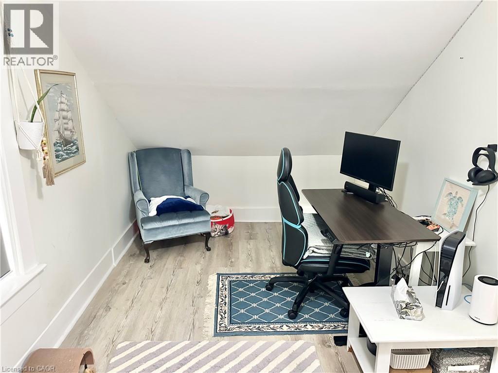Second Floor - office or bedroom featuring wood-finish flooring, white baseboards, and a window with white trim - 88 Brook Street, Simcoe, ON - Indoor Photo Showing Office