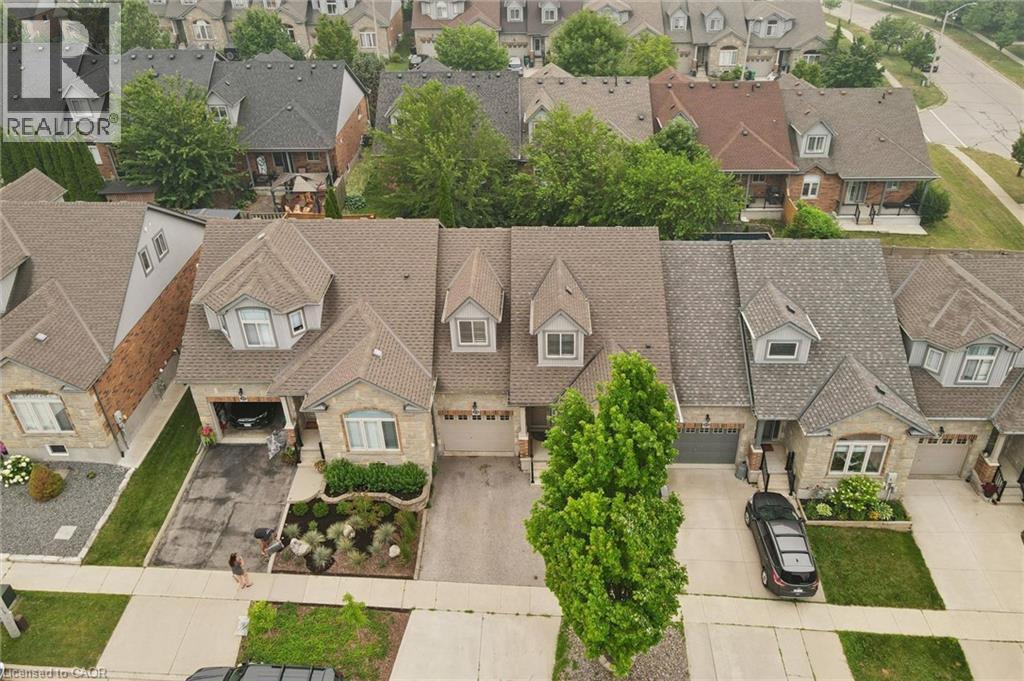 Stone facade residence with dual dormer windows and an attached garage - 23 Knack Lane, Cambridge, ON - Outdoor With Facade