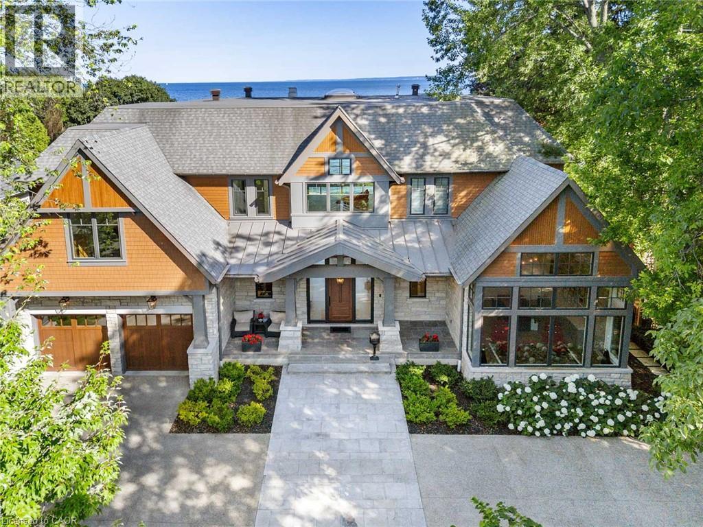 Craftsman-style facade featuring stone accents, wood shingle siding, and a prominent peaked roofline - 140 Secord Lane, Burlington, ON - Outdoor With Deck Patio Veranda With Facade