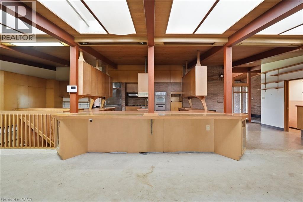 Expansive open-concept kitchen and living area featuring a breakfast bar, wood-finish cabinetry, a built-in oven, and recessed ceiling lighting - 264 Mountain Brow Boulevard, Hamilton, ON - Indoor Photo Showing Kitchen