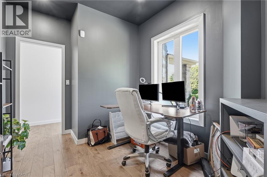 Dedicated workspace featuring a large window, light wood-finish flooring, and built-in shelving - 5779 Third Line, Guelph/Eramosa, ON - Indoor Photo Showing Office