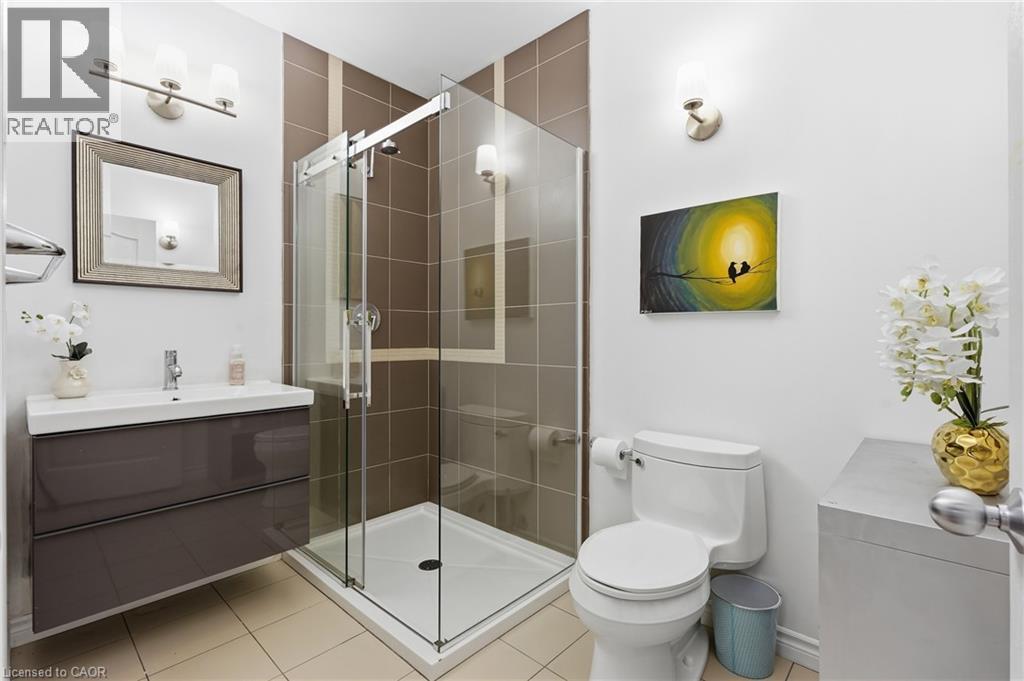 Modern bathroom featuring a glass-enclosed shower with brown tiled walls - 5779 Third Line, Guelph/Eramosa, ON - Indoor Photo Showing Bathroom