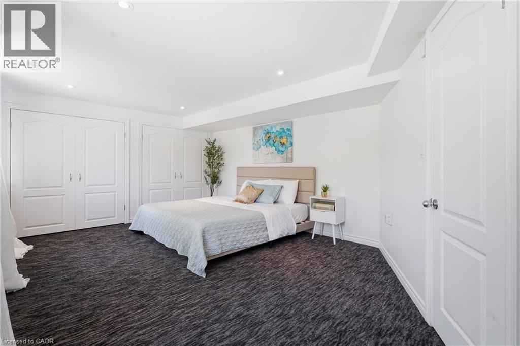 Spacious room featuring textured dark carpeting, recessed lighting, white walls, and multiple panel doors - 5779 Third Line, Guelph/Eramosa, ON - Indoor Photo Showing Bedroom