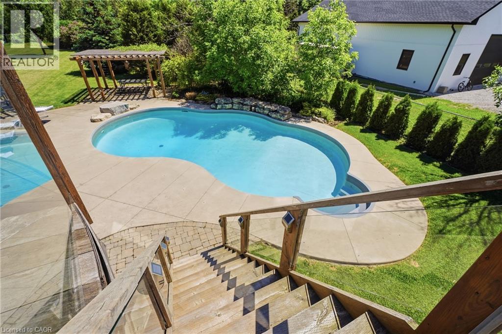 Freeform inground pool with concrete surround - 5779 Third Line, Guelph/Eramosa, ON - Outdoor With In Ground Pool With Backyard