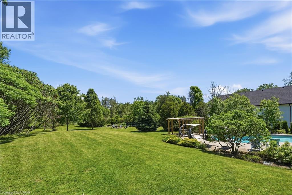 Expansive green lawn with mature trees and a dedicated pool area - 5779 Third Line, Guelph/Eramosa, ON - Outdoor