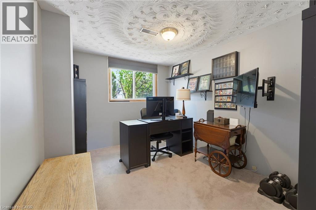 Light-filled room featuring a window overlooking greenery, recessed ceiling lighting, textured ceiling details, and neutral wall tones - 164 Hanover Place, Hamilton, ON - Indoor Photo Showing Office