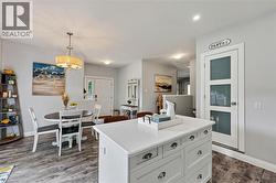 Kitchen island with white cabinetry and integrated storage drawers -