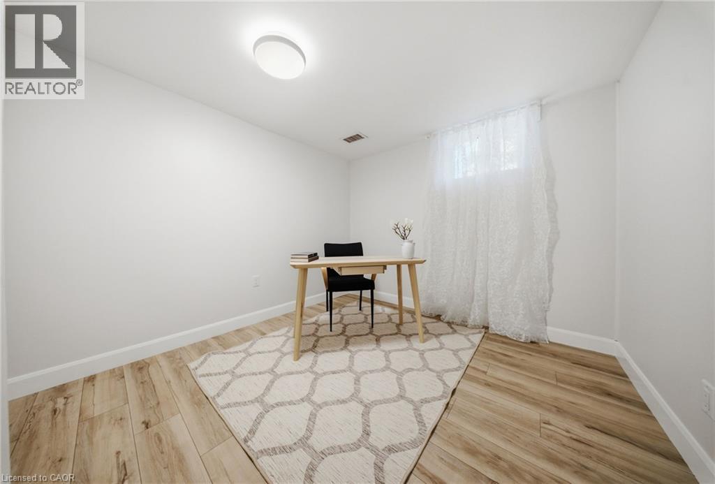 Bright room with wood-finish flooring, crisp white walls, and a recessed window - 80 Jackson Avenue, Kitchener, ON - Indoor Photo Showing Other Room