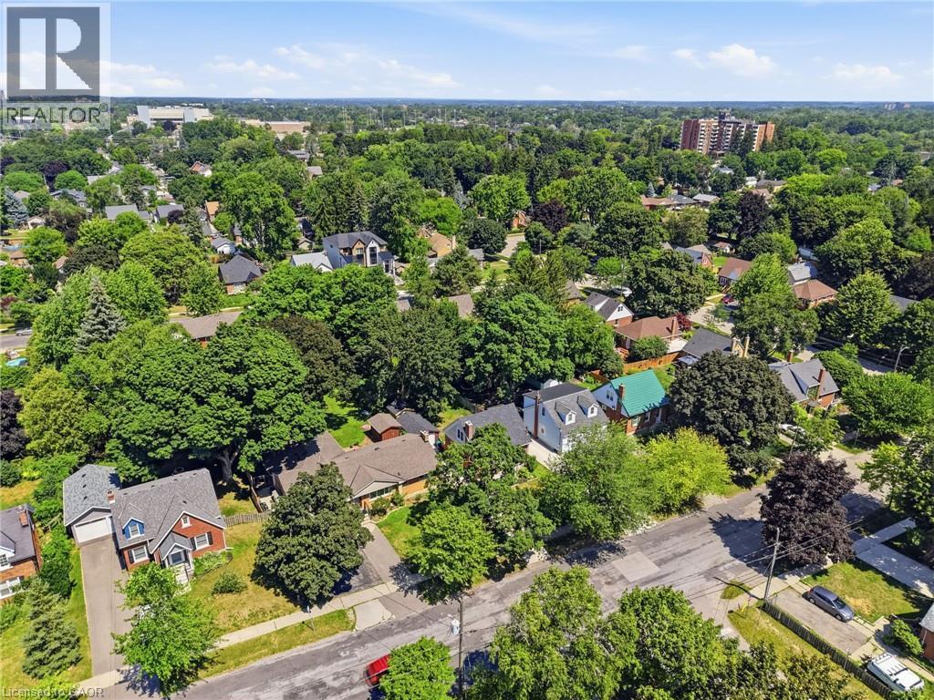 Aerial view of a residential neighborhood with extensive tree canopies, residential streets, and diverse architectural styles - 80 Jackson Avenue, Kitchener, ON - Outdoor With View
