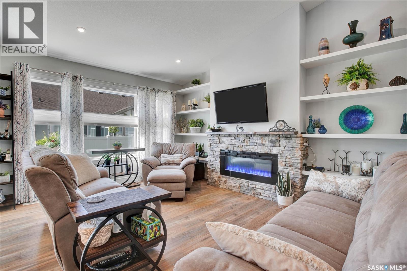 4 437 Palmer Crescent, Warman, SK - Indoor Photo Showing Living Room With Fireplace