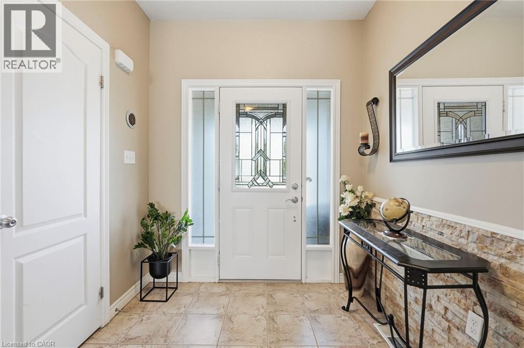 Inviting entry featuring a front door with leaded glass, side lites, and a transom window - 1332 Baseline Road, Stoney Creek, ON - Indoor Photo Showing Other Room
