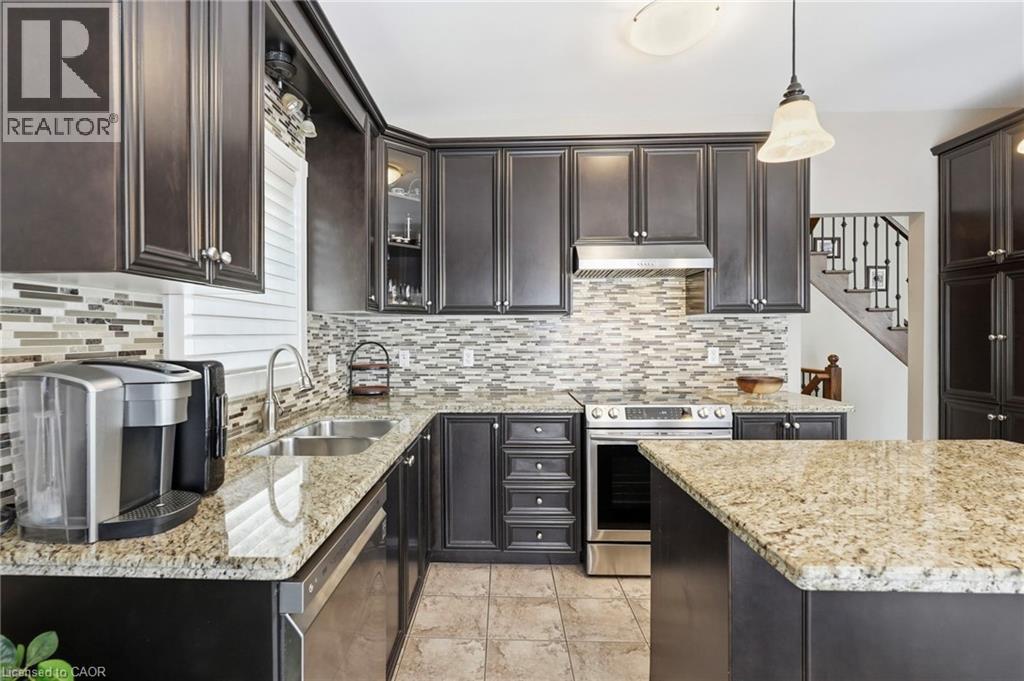 Kitchen featuring dark wood-finish cabinetry and light-toned granite countertops - 1332 Baseline Road, Stoney Creek, ON - Indoor Photo Showing Kitchen With Double Sink With Upgraded Kitchen